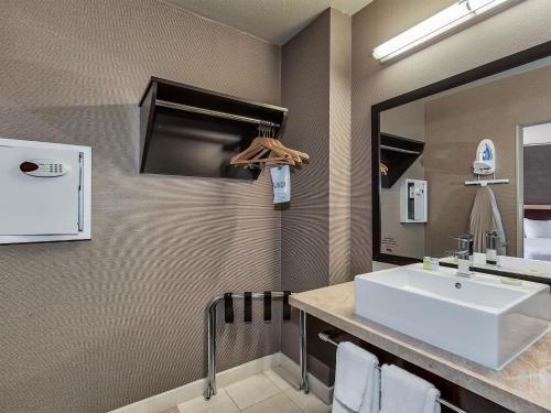 a bathroom with a white sink and a mirror at Plaza Hotel & Casino in Las Vegas