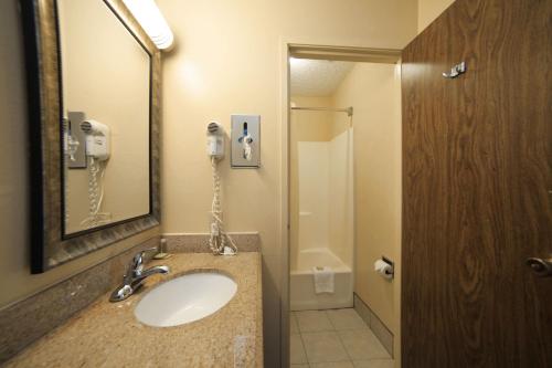 a bathroom with a sink and a phone at Super 8 by Wyndham Natchitoches in Natchitoches