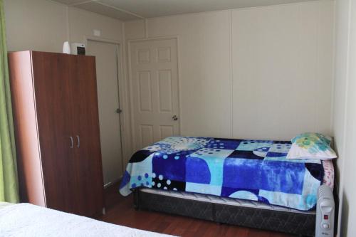 a bedroom with a bed and a dresser at Casa Ollagua in Vicuña