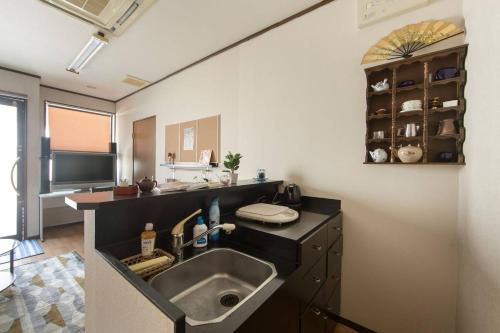 a kitchen with a sink and a counter at Close to Golden temple -Kinkakuji- in Kyoto
