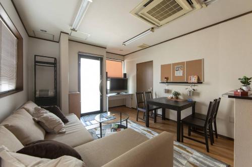 a living room with a couch and a table at Close to Golden temple -Kinkakuji- in Kyoto