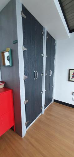 a row of lockers in a room with wood floors at Magenta in Donghae