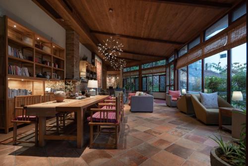 a large living room with a table and chairs at The Apsara Lodge-Airport or TS Free pick-up over 3 nights in Yangshuo