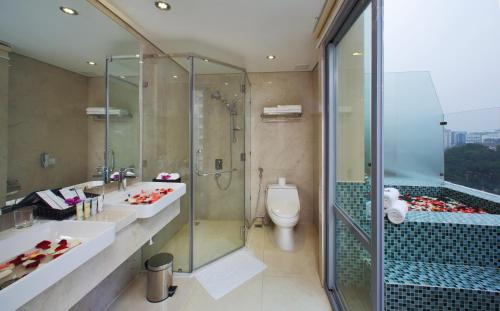 a bathroom with a shower and a sink and a toilet at Paradise Saigon Boutique Hotel & Spa in Ho Chi Minh City