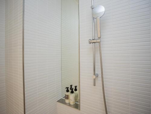 a shower with a glass door in a bathroom at The Place Taichung in Taichung