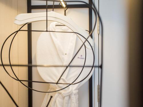 a white shirt is hanging on a rack at The Place Taichung in Taichung