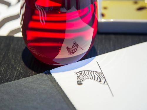 a red vase sitting on a table next to a piece of paper at The Place Taichung in Taichung
