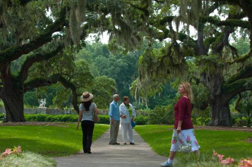 a group of people walking down a path in a park at Oceanfront Litchfield Inn in Pawleys Island