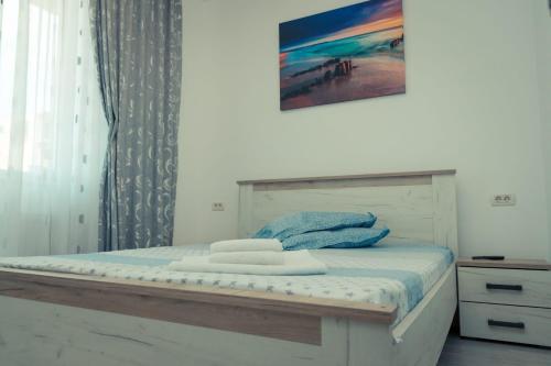 a bedroom with a bed with towels on it at Apartament #LUNA MAMAIA N in Mamaia Nord