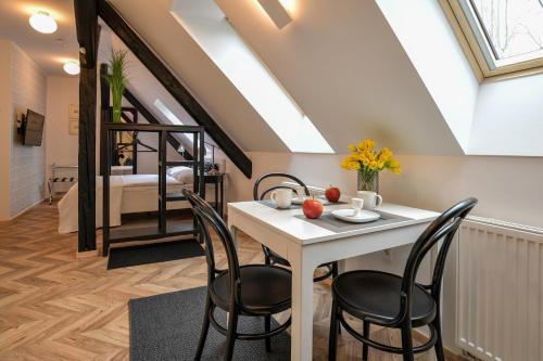 a dining room with a white table and chairs at Vila Selena in Ljubljana