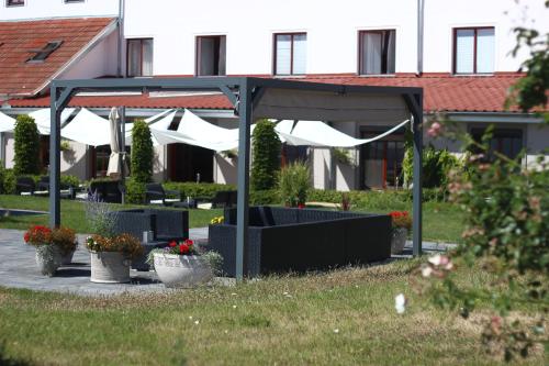 a pavilion with plants and flowers in a park at Hotel Maroli Mikulov in Mikulov