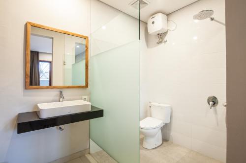 a bathroom with a sink and a toilet at Eclipse Kerobokan in Kerobokan