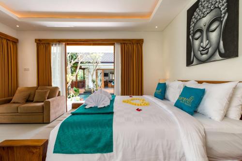 a bedroom with a large bed and a couch at The Pesaren Ubud in Ubud