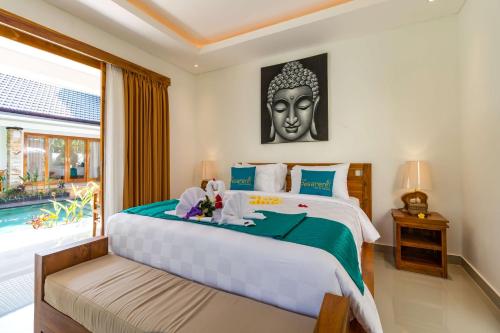 a bedroom with a large bed and a large window at The Pesaren Ubud in Ubud