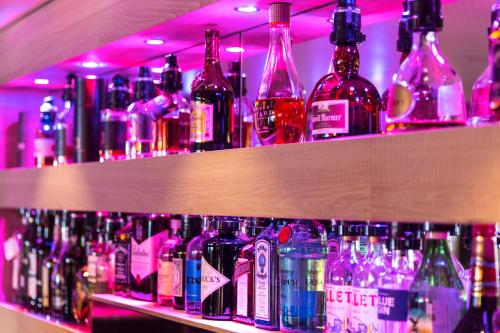 a bar with lots of bottles of alcohol at hirschen dornbirn - das boutiquestyle hotel - skyrelax & wellness im rooftop in Dornbirn