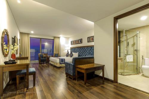 a hotel room with a bed and a bathroom at Balcona Hotel Da Nang in Da Nang