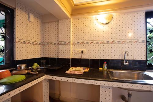a kitchen with a sink and a counter top at Casa Margarida in Calangute