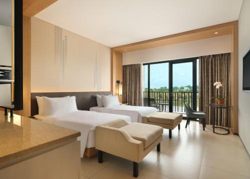 Postel nebo postele na pokoji v ubytování Hotel Santika Premiere Bandara Palembang