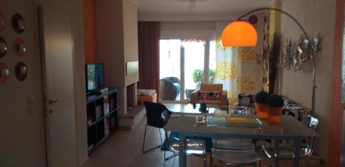 a dining room and living room with a table and chairs at Magic Mola in Mola Kalyva