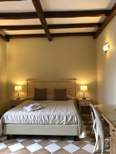a bedroom with a bed with two tables and two lamps at Krimar Hotel in San Vito lo Capo
