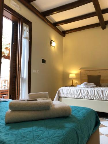 a bedroom with two beds and a window at Krimar Hotel in San Vito lo Capo