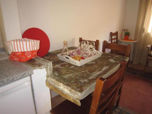 a table with a bowl of fruit and glasses on it at Casas Botelho Elias in Pinhão