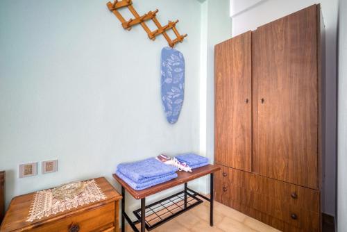 a room with a table and a wooden cabinet at Lefteri's Rooms in Agia Galini