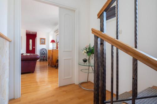 a hallway with a staircase and a living room at Boutique Guest Accommodation Zephyrus in Split