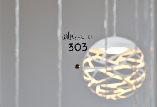 a clock with a doughnut hanging from a door at ABC Hotel in Blankenberge