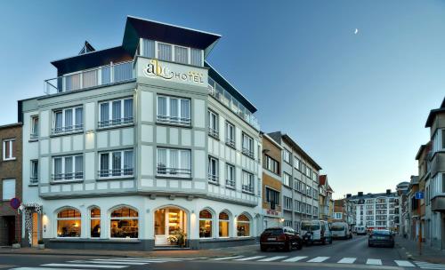 
a large building with a clock on the front of it at ABC Hotel in Blankenberge
