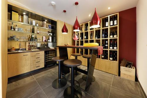 a bar in a wine cellar with two stools at Hotel Neuhausmühle in Vilpiano