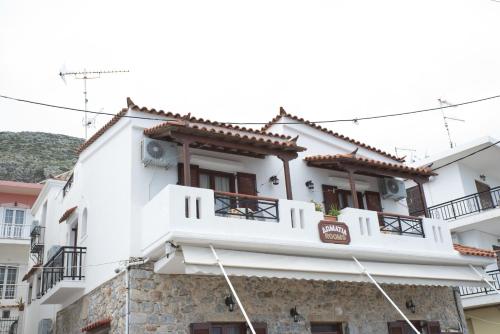 a white building with a sign on it at AGNANTIO in Monemvasia