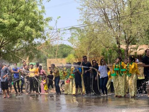 a group of people standing in the rain cutting a ribbon at The Hotel Umbra Bagan in Bagan