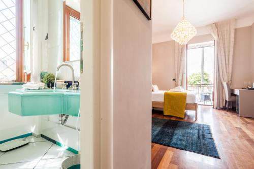 a bathroom with a blue sink and a bedroom at Dream House Pompei in Pompei