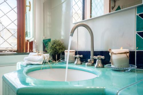a bathroom sink with water coming out of it at Dream House Pompei in Pompei
