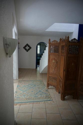 a room with a rug on the floor and a staircase at Villa Talassa in Le Morne