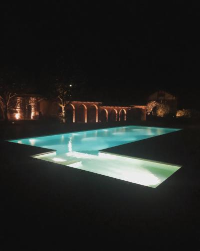 a swimming pool lit up at night at Villa Vitali - Bellagio in Bellagio
