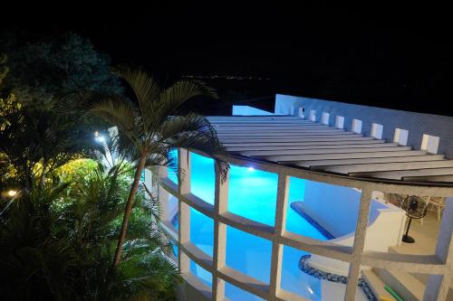 a view of a swimming pool at night at Villa Talassa in Le Morne