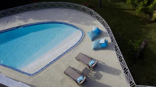 an overhead view of a swimming pool with two lawn chairs and avisor at Villa Talassa in Le Morne