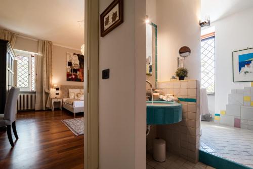 a bathroom with a sink and a living room at Dream House Pompei in Pompei