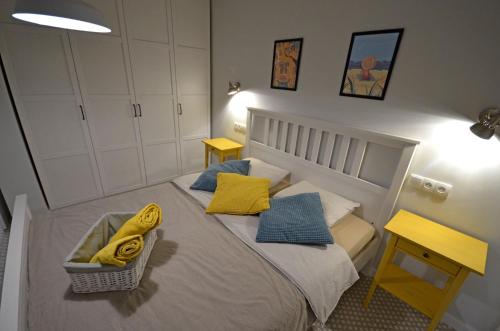 a small bedroom with a bed with yellow pillows at Ferienwohnung PRESIDENTE - Pool - Glasfaserinternet - Costa Calma in Costa Calma