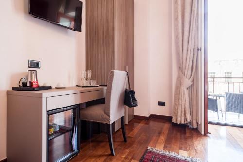 a desk with a chair in a room with a window at Dream House Pompei in Pompei
