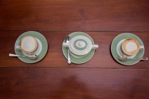 two cups of coffee sitting on top of a table at CASA VACANSA HOME STAY in Hungama