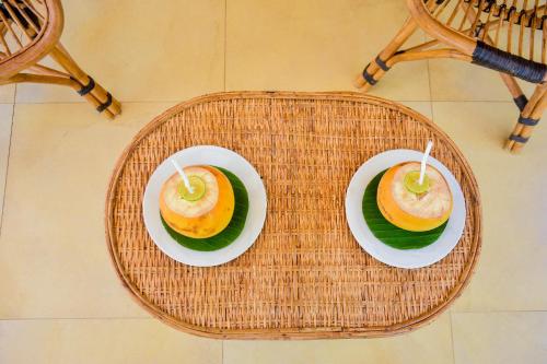 two plates of food on a wicker table at CASA VACANSA HOME STAY in Hungama
