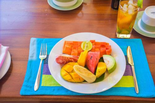a white plate of fruit on a table at CASA VACANSA HOME STAY in Hungama