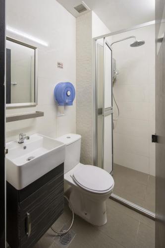a bathroom with a toilet and a sink and a shower at 7 Wonders Hostel at Upper Dickson in Singapore