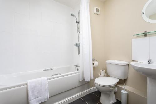 a white bathroom with a toilet and a sink at Lloyd Close Cheltenham - Close to Town Centre & GCHQ in Cheltenham