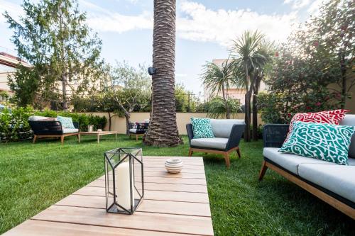 a patio with chairs and a table in the grass at Dream House Pompei in Pompei