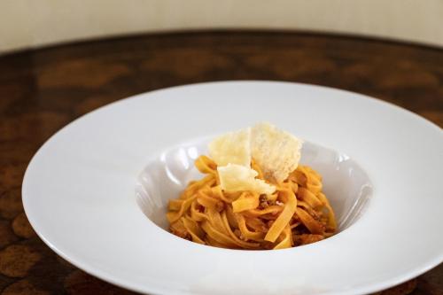 a white bowl of food on a table at Grand Hotel President in Olbia