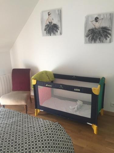 a bed with a dresser in a bedroom at Rue de la Gare in Prouzel